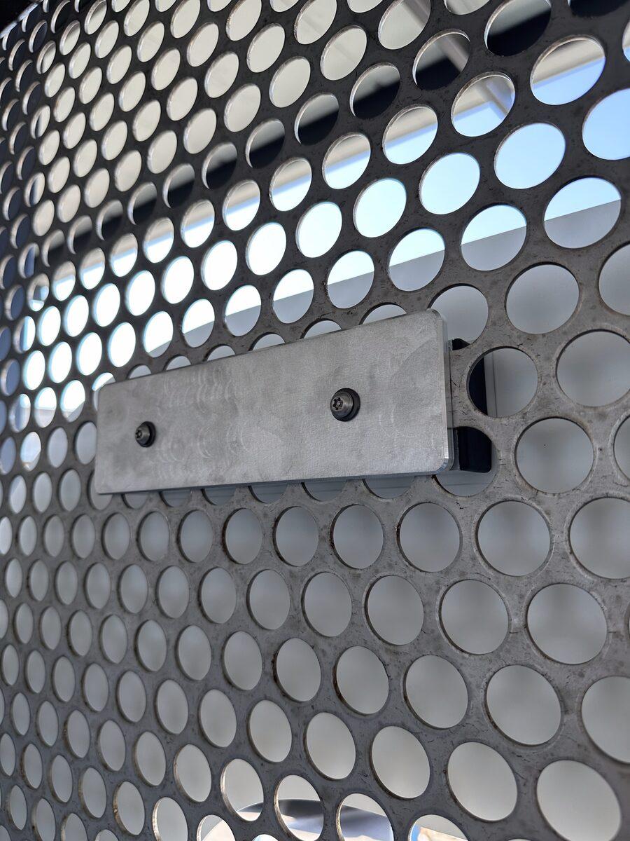 Custom dimensional letter brackets on mesh panels for Dennis+Ives — by CG Signs Jacksonville FL